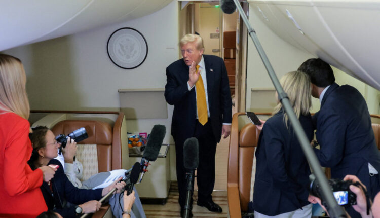 U.S. President Trump speaks to reporters mid-flight in the press cabin of the new Air Force One